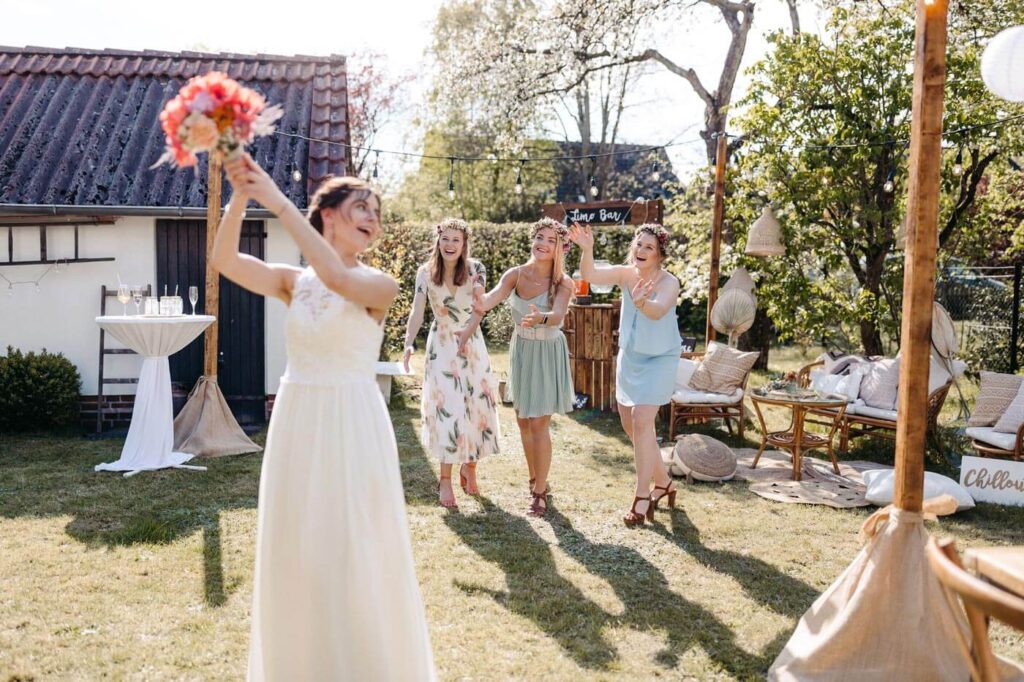 Braut wirft ihren Brautstrauss zu den Brautjungern Braut wirft ihren Brautstrauss zu den Brautjungern