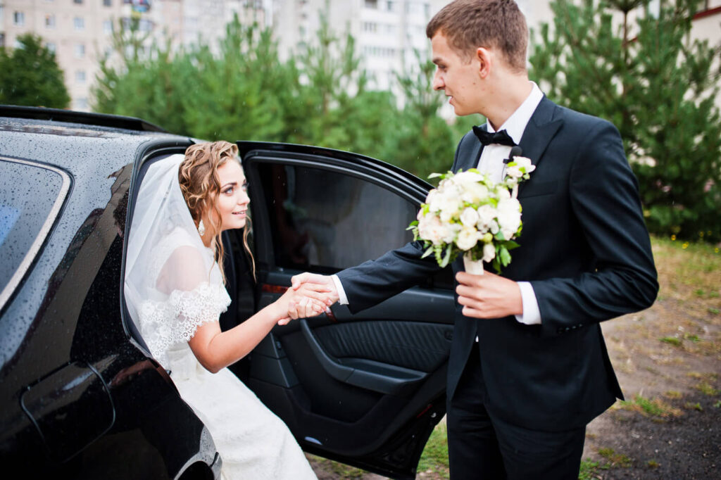 groom-and-bride-near-wedding-car-2021-09-02-12-44-44-utc