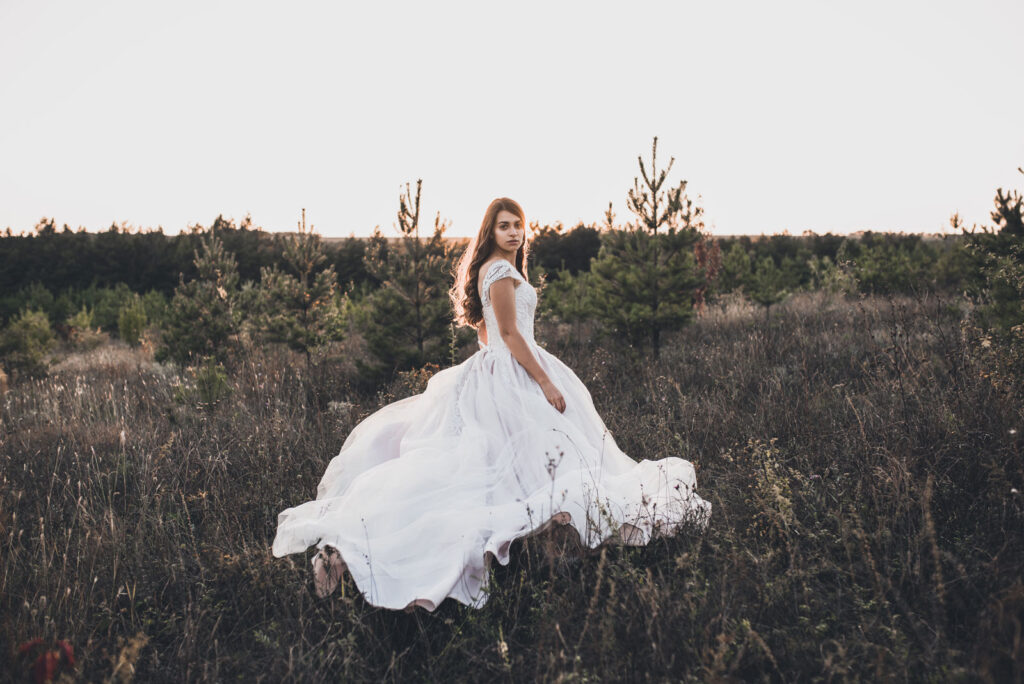 bride-in-wedding-white-dress-walking-on-meadow-in-2022-02-14-21-39-49-utc